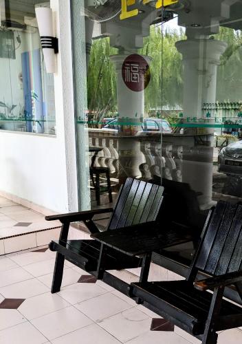 a couple of benches sitting in front of a building at EnE Sri Cemerlang in Kota Bharu