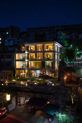 a large building with lights on in a city at night at 慢境Slow Land半山海景花园酒店 in Dali
