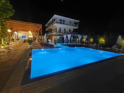 a swimming pool in front of a building at night at Agorastos Luxury Living in Platamonas