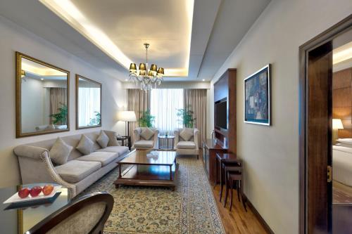 a living room with a couch and a table at Islamabad Marriott Hotel in Islamabad