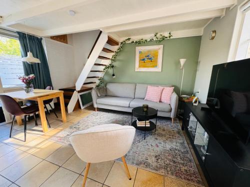 a living room with a couch and a table at Balsemientexel in De Koog