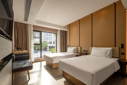 Katil atau katil-katil dalam bilik di Xiamen Lujiang Mingjia Hotel