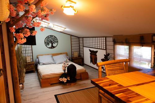 a bedroom with a bed and a table in it at Les Chambres de Paulette a thème LA ZEN in Sainte-Marie-la-Mer