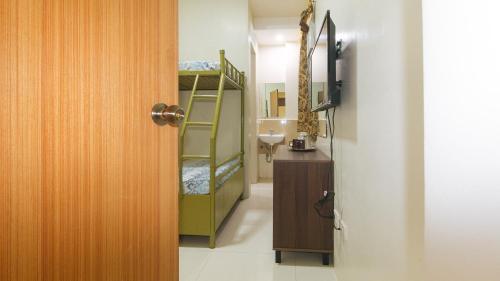 a bathroom with a staircase leading to a room with a sink at CM Apartelle Iloilo International Airport by RedDoorz in Cabatuan