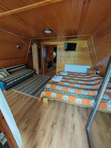 a bedroom with a bed in a wooden cabin at A Frame Alpin in Vatra Dornei