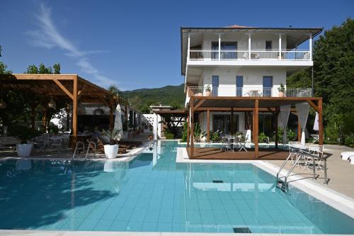 a swimming pool in front of a building at Agorastos Luxury Living in Platamonas
