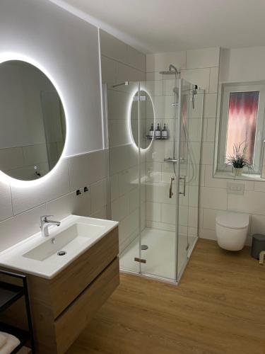 a bathroom with a sink and a glass shower at Visit Oberhof 2 in Oberhof