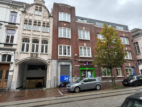 a gray car parked in front of a brick building at Belfort Shortstay in Ghent
