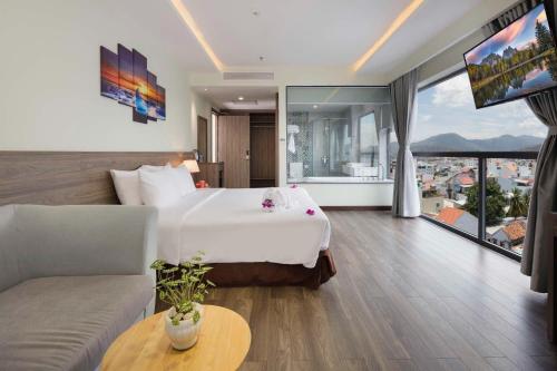 a hotel room with a bed and a couch at Xavia Hotel in Nha Trang