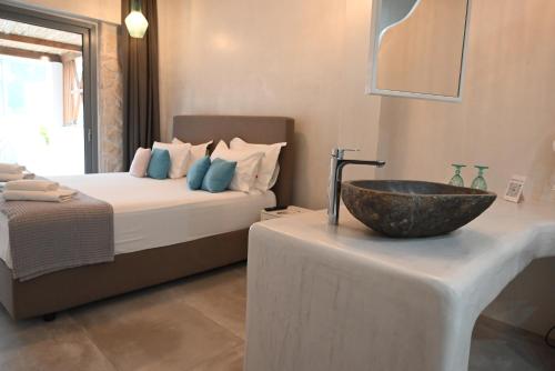 a bathroom with a bed and a bowl on a table at Agorastos Luxury Living in Platamonas