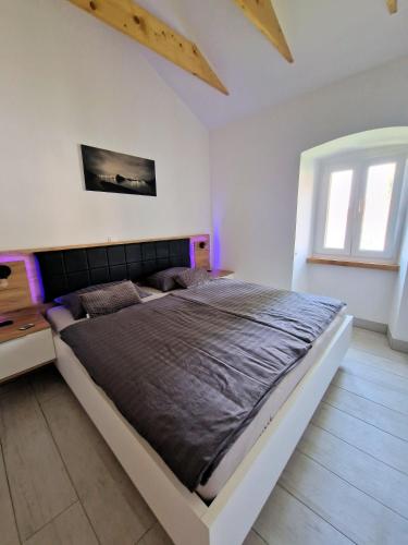a bedroom with a large bed with purple lighting at Villa Lavanda in Čižići