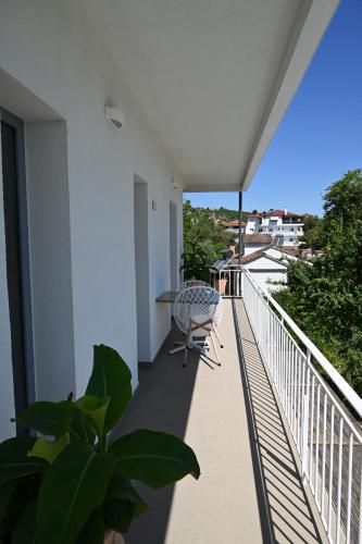 a balcony with a table and a chair on it at Agorastos Luxury Living in Platamonas