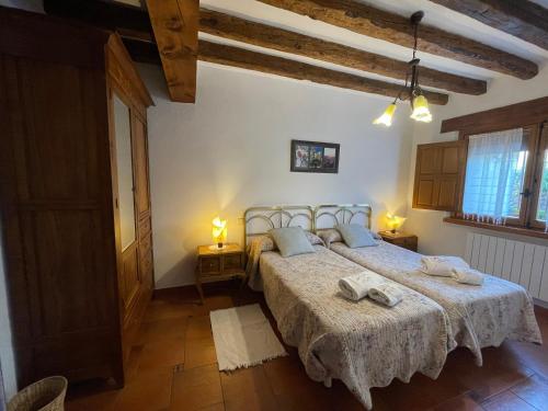 Postel nebo postele na pokoji v ubytování Agroturismo El Mirador de la Cigüeña