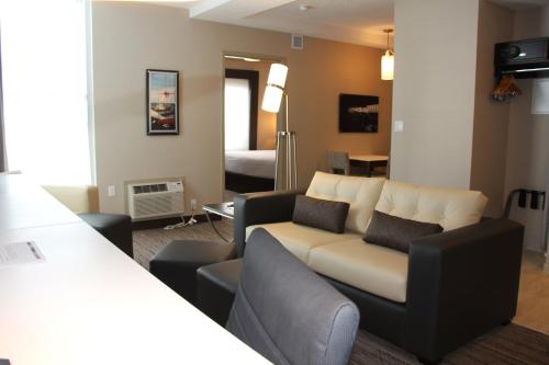 a living room with a couch and a bedroom at Holiday Inn Express & Suites Cold Lake by IHG in Cold Lake