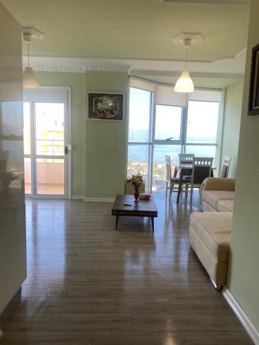 a living room with a couch and a table at penthouse with seaveiw in Vlorë