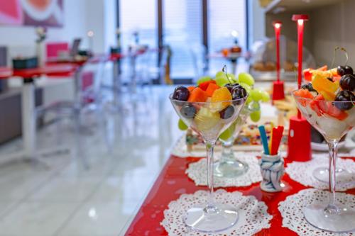 two wine glasses filled with fruit on a table at Fazio Rooms in Sciacca