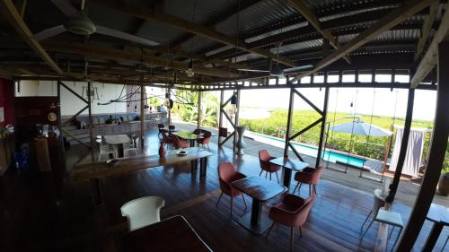 a room with a table and chairs and a large window at Villa F&B in Bocas del Toro