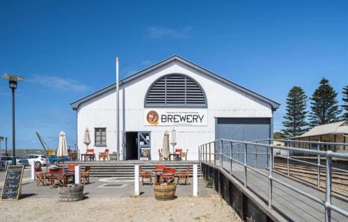 a large white building with a brewery sign on it at Syds Place A 70s retro beach house Free WIFI in Goolwa South