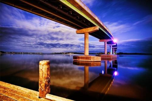 a bridge over a body of water at night at Syds Place A 70s retro beach house Free WIFI in Goolwa South