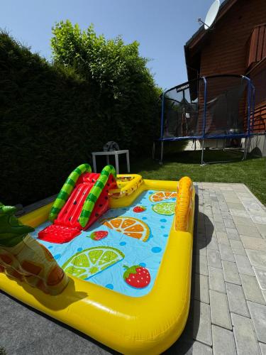 a childs inflatable inflatablericularricularricularricular play equipment in a backyard at Chata Fir in Valča