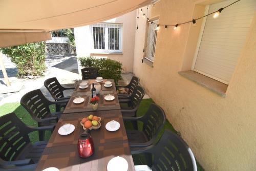 a wooden table and chairs on a patio at RNET - MT - Casa Can Carles in Roses