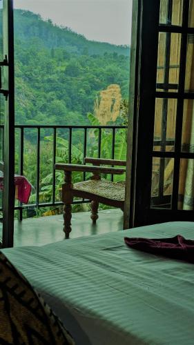 a room with a bed and a bench on a balcony at Rock Grand View in Ella