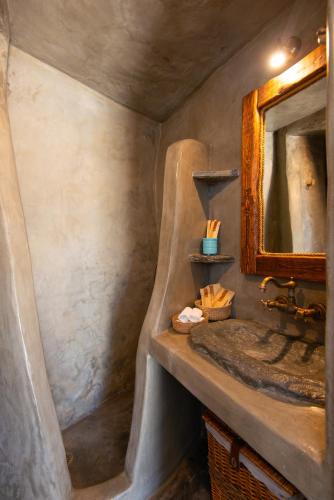a bathroom with a sink and a mirror at Sifnos Roots in Exámbela