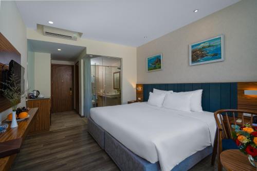 a hotel room with a large bed and a bathroom at Sala Tuy Hoa Beach Hotel in Tuy Hoa