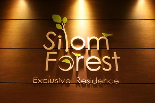 a sign for a show forest exclusive restaurant at Silom Forest Exclusive Residence in Bangkok