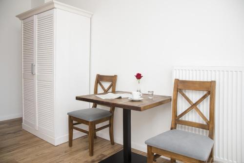 a table and two chairs and a table and a cabinet at Tawerna Panorama in Stepnica