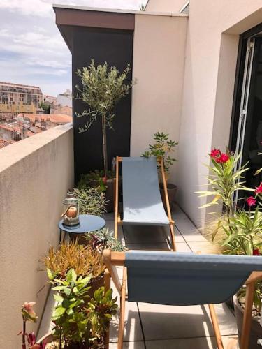 d'un balcon avec une chaise, une table et des plantes dans l'établissement Soho So Chic Apartment with terraces, à Marseille