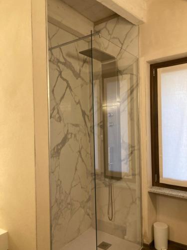 a shower with a glass door in a bathroom at Vista B&B in Pella
