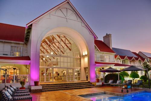 an exterior view of a resort with a swimming pool at Courtyard Hotel Gqeberha in Port Elizabeth