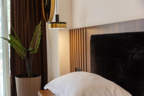 a bedroom with a white pillow and a potted plant at Apartments Milla in Ulcinj
