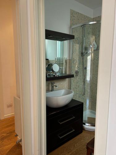 a bathroom with a sink and a shower at Piccinni Exclusive Suite 182 in Bari