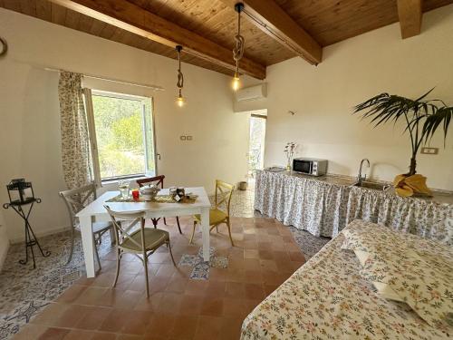 a living room with a table and a kitchen at Casa Sangineto - Minori - Costa Amalfitana- A Paradise in the countryside in Minori