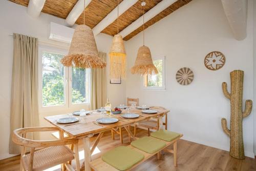 a dining room with a wooden table and chairs at Picasso Mountain View Begur in Begur