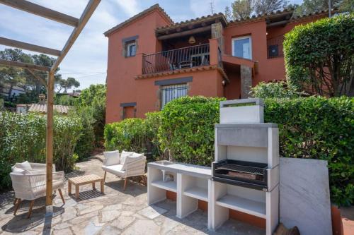 a backyard with a grill and a house at Picasso Mountain View Begur in Begur