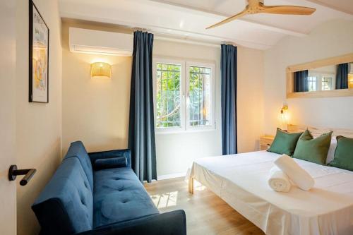 a bedroom with a bed and a couch and a window at Picasso Mountain View Begur in Begur