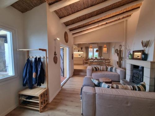 a living room with two couches and a fireplace at Picasso Mountain View Begur in Begur
