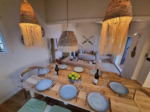 a dining room table with wine bottles and fruit on it at Picasso Mountain View Begur in Begur