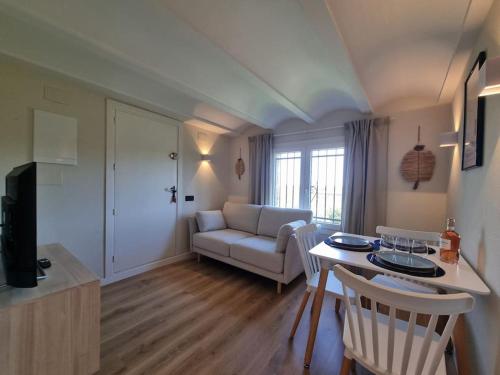 a living room with a couch and a table at Picasso Mountain View Begur in Begur