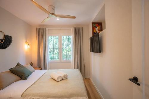a bedroom with a bed with two towels on it at Picasso Mountain View Begur in Begur
