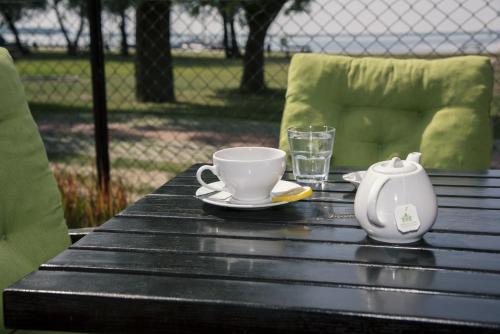 a black table with a cup and a tea pot on it at Tawerna Panorama in Stepnica
