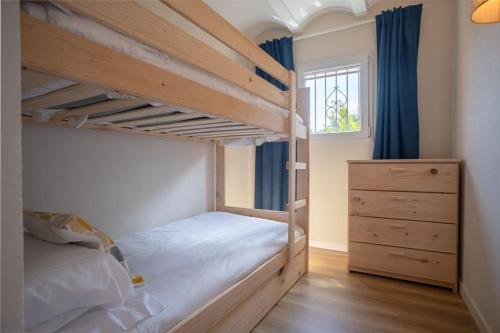 a bedroom with two bunk beds and a dresser at Picasso Mountain View Begur in Begur
