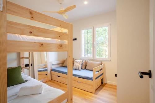 a bedroom with two bunk beds and a ceiling fan at Picasso Mountain View Begur in Begur