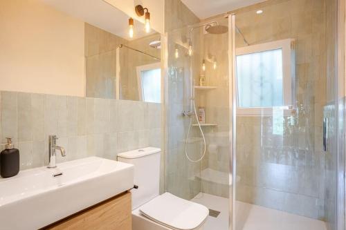 a bathroom with a shower and a toilet and a sink at Picasso Mountain View Begur in Begur