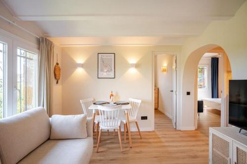a living room with a couch and a table and chairs at Picasso Mountain View Begur in Begur