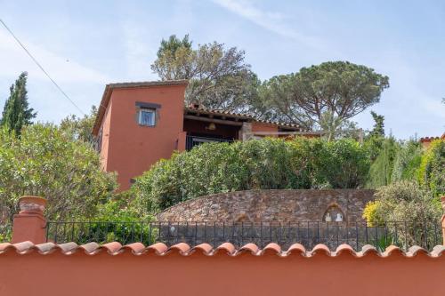 a house with a fence in front of it at Picasso Mountain View Begur in Begur