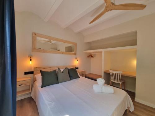 a bedroom with a large white bed with a ceiling at Picasso Mountain View Begur in Begur